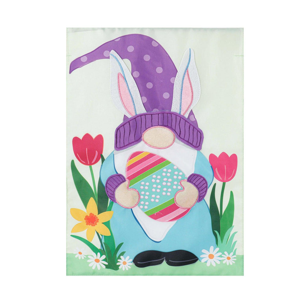 The Easter Gnome Bunny Ears garden flag features a gnome with a purple hat and bunny ears holding an Easter egg.
