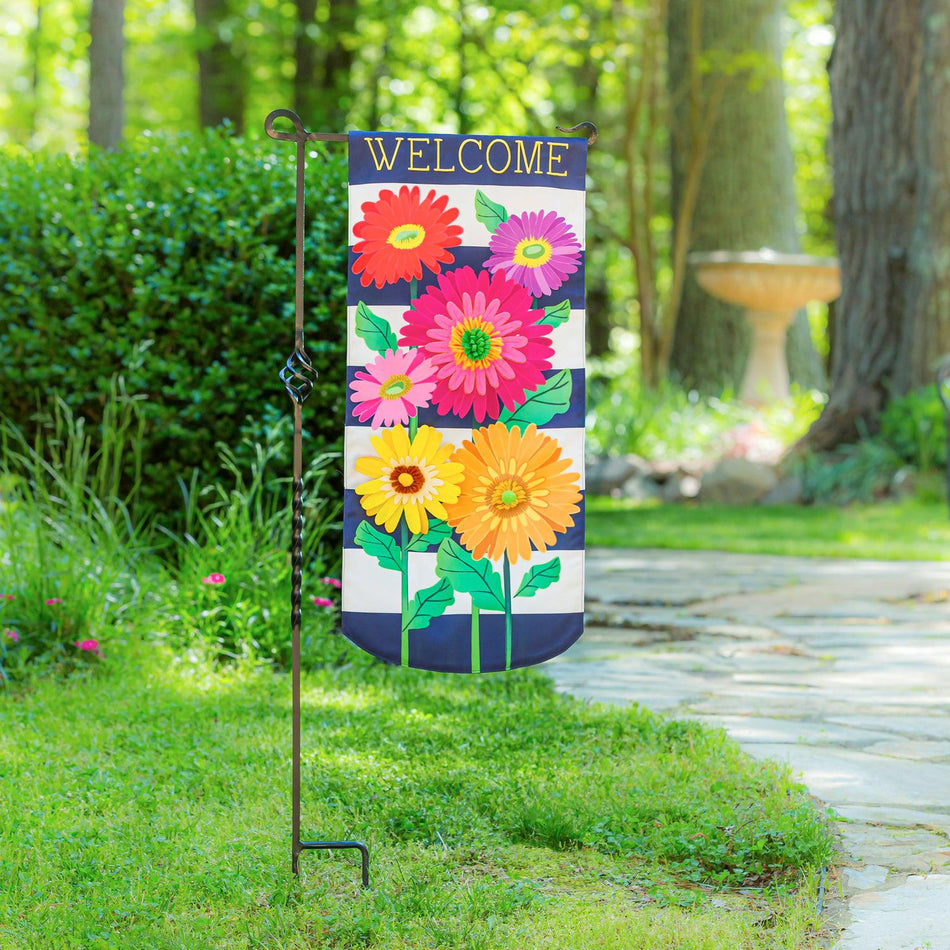 Enjoy the beauty of the Gerbera Daisy Stripe Textile Décor from the Everlasting Impressions collection. This extra-long garden flag features colorful gerbera daisies over a navy and white striped background and the word "Welcome" across the top.