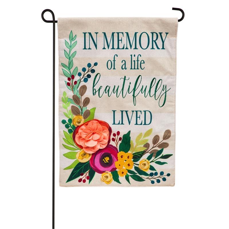 Perfect for remembering someone special, the "In Memory of a Life Beautifully Lived" garden flag features a 3D floral design on an ivory background.