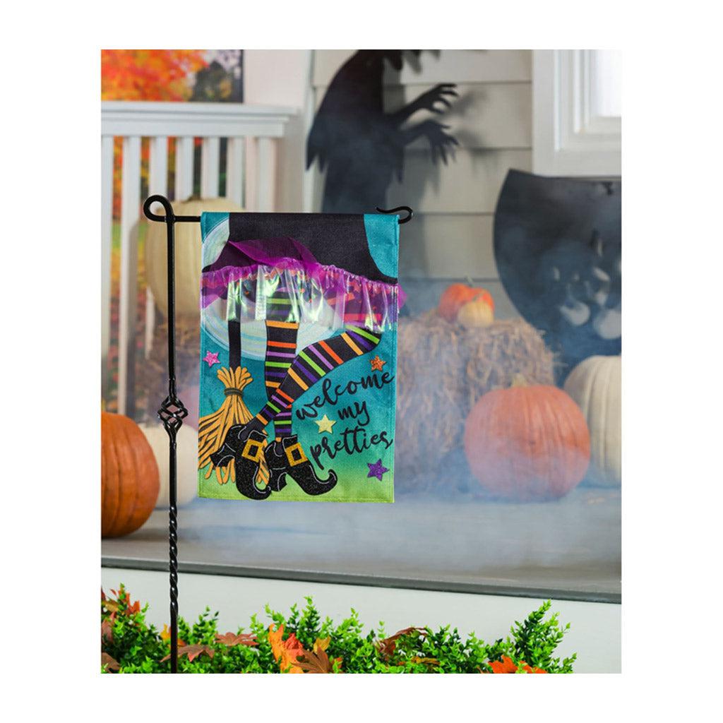 The My Pretties garden flag features a witch's skirt, striped legs and broom and the words "Welcome My Pretties". 