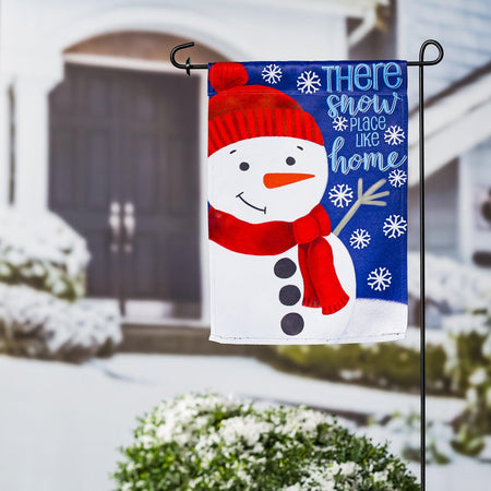 The There's Snow Place Like Home garden flag features a happy snowman with a red hat and scarf.