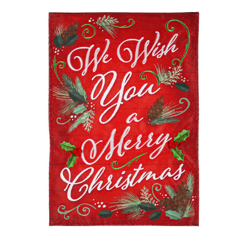 The We Wish You A Merry Christmas garden flag features the words "We Wish You A Merry Christmas" accented by pine and holly on a bright red background.