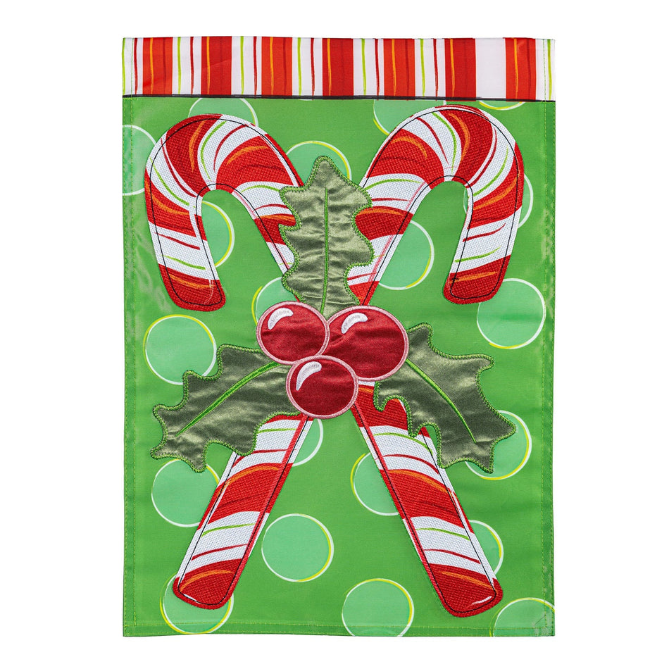 Candy Cane Christmas Garden Flag Features 2 candy canes crossed with a green background 
