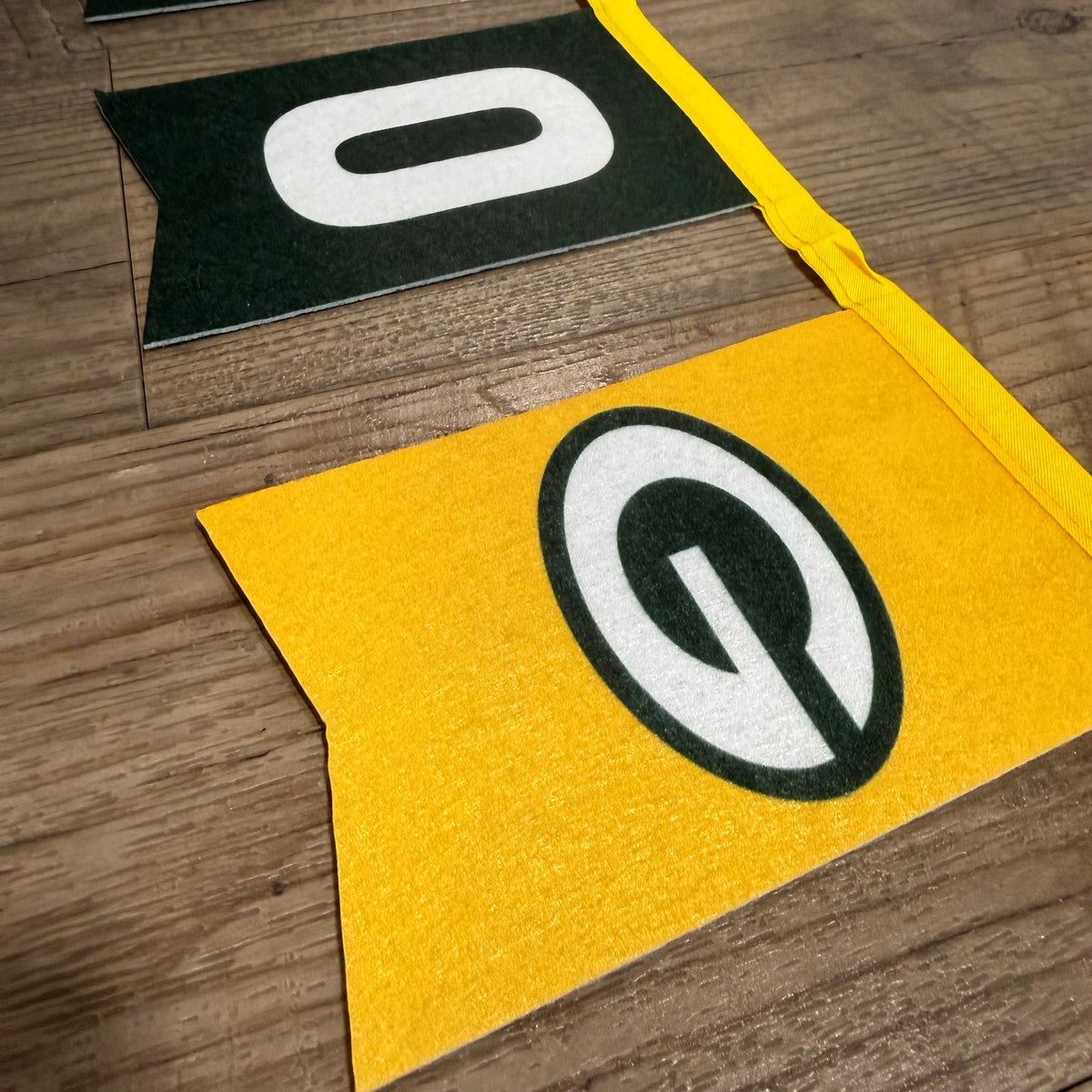 Close up of the G logo on the felt yellow pennant.