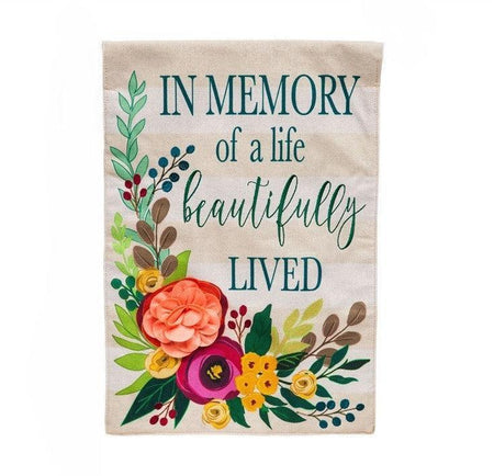 This garden flag features a floral design with the words in memory of a life  beautifully lived