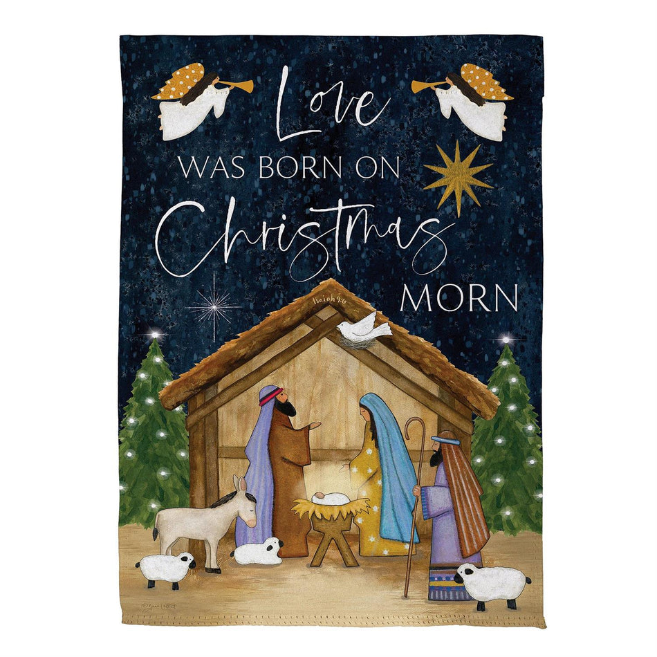 Love was Born Garden Flag Features a manger scene with the word "Love was born on Christmas morn"