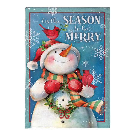Merry Snowman With Cardinal Garden Flag Features a Snowman holding a wreath with the words " tis the season to be merry"