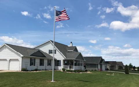USA flag flying after flagpole installation in Green Bay, WI.