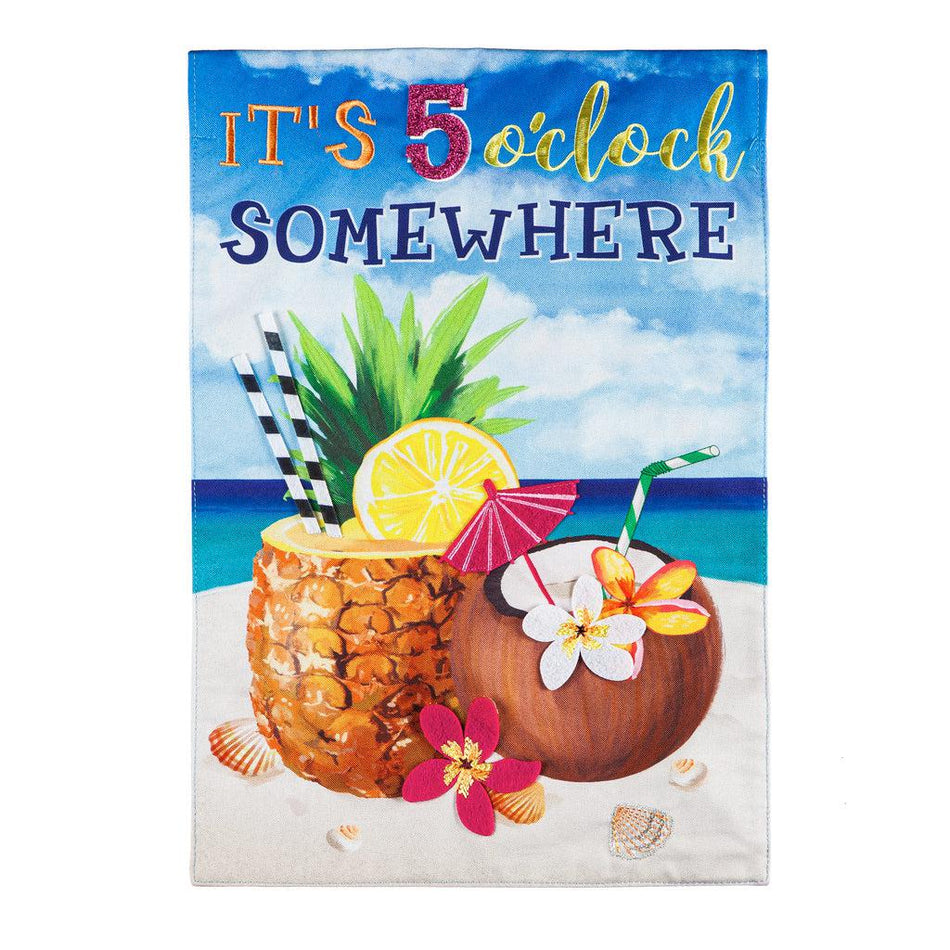 The 5 O'Clock Somewhere Beach garden flag features tropical drinks sitting in sand at the beach and the words "It's 5 O'Clock Somewhere". 