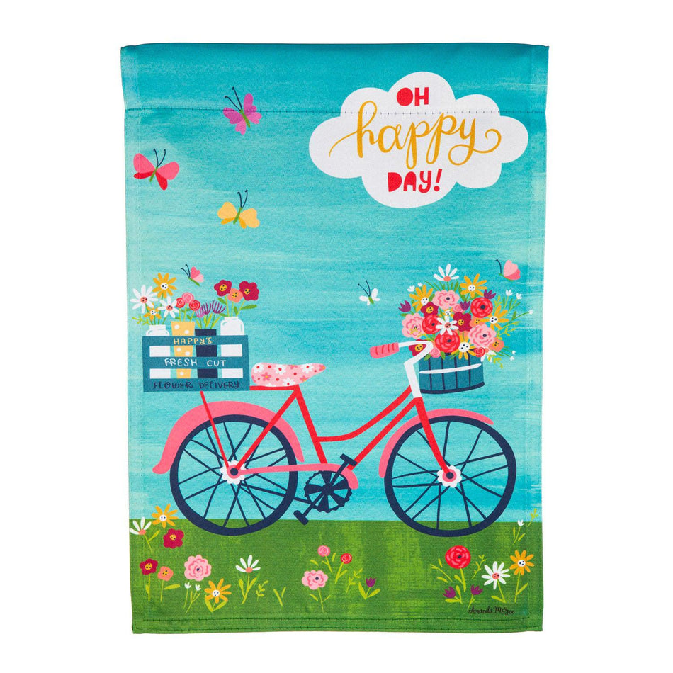 The Bike Ride Blooms garden flag features a pink bicycle with baskets full of flowers and the words" Oh Happy Day".