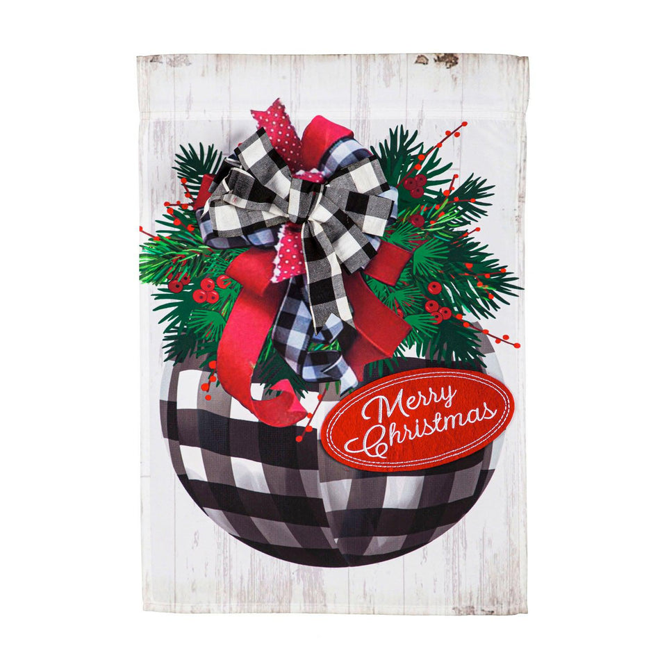 The Buffalo Check Ornament garden flag features a checked ornament with bows and pine along with the words "Merry Christmas". 