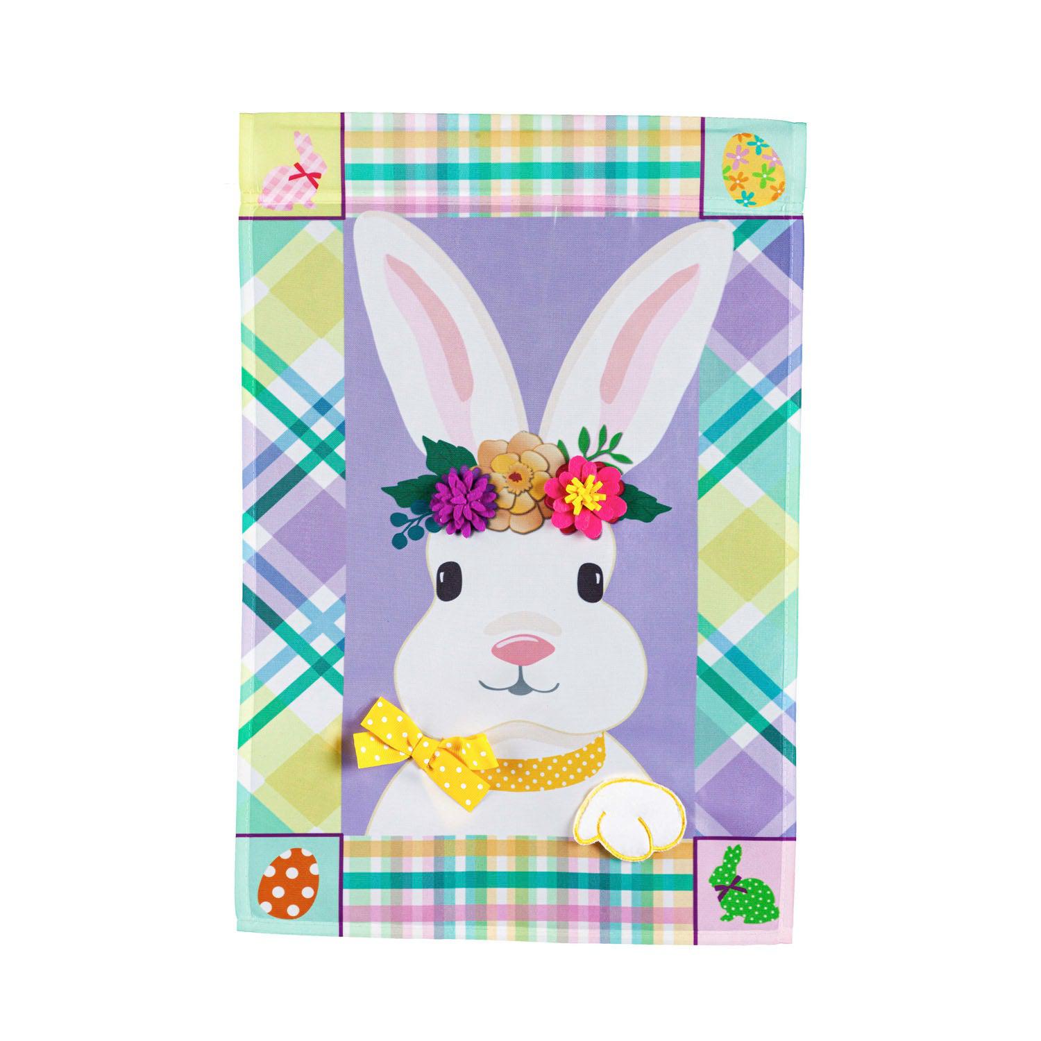 The Bunny Patterned Border garden flag features a white bunny with a crown of flowers and yellow ribbon with a multi-colored and patterned border. 