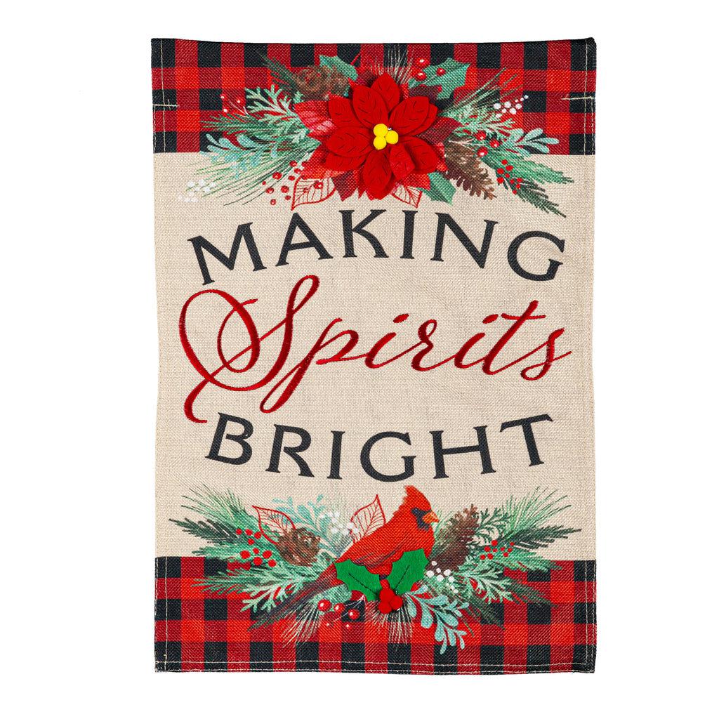 The Christmas Joy garden flag features a poinsettia, a cardinal, a black and red checked border, and the words "Making Spirits Bright".