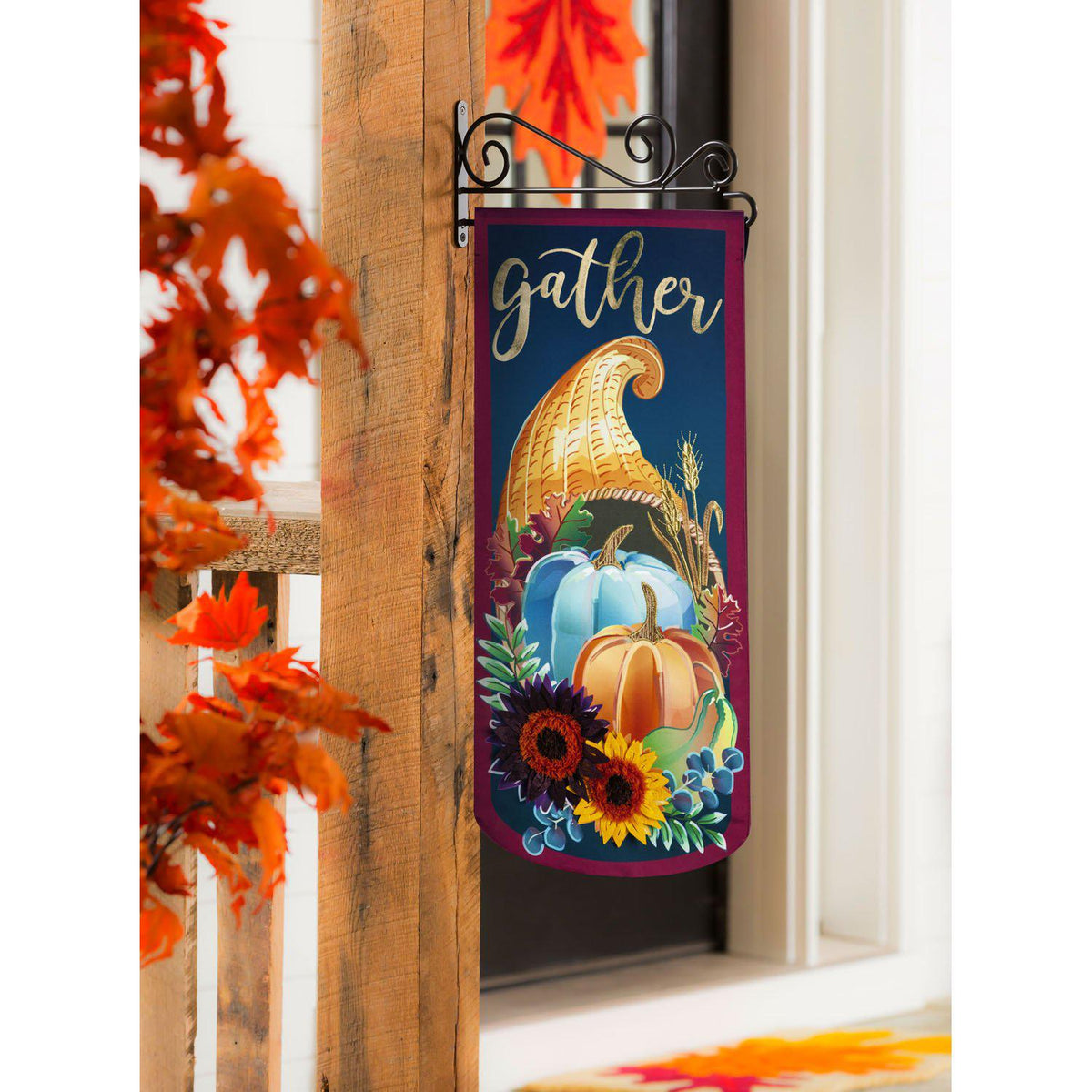 The  Cornucopia Gather Textile Decor from the Everlasting Impressions collection features a cornucopia spilling out pumpkins and flowers and the word "Gather". 