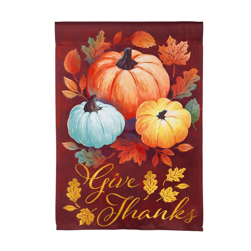 The Crafted harvest garden flag features brilliantly colored Autumn leaves, pumpkins, and the words "Give Thanks". 