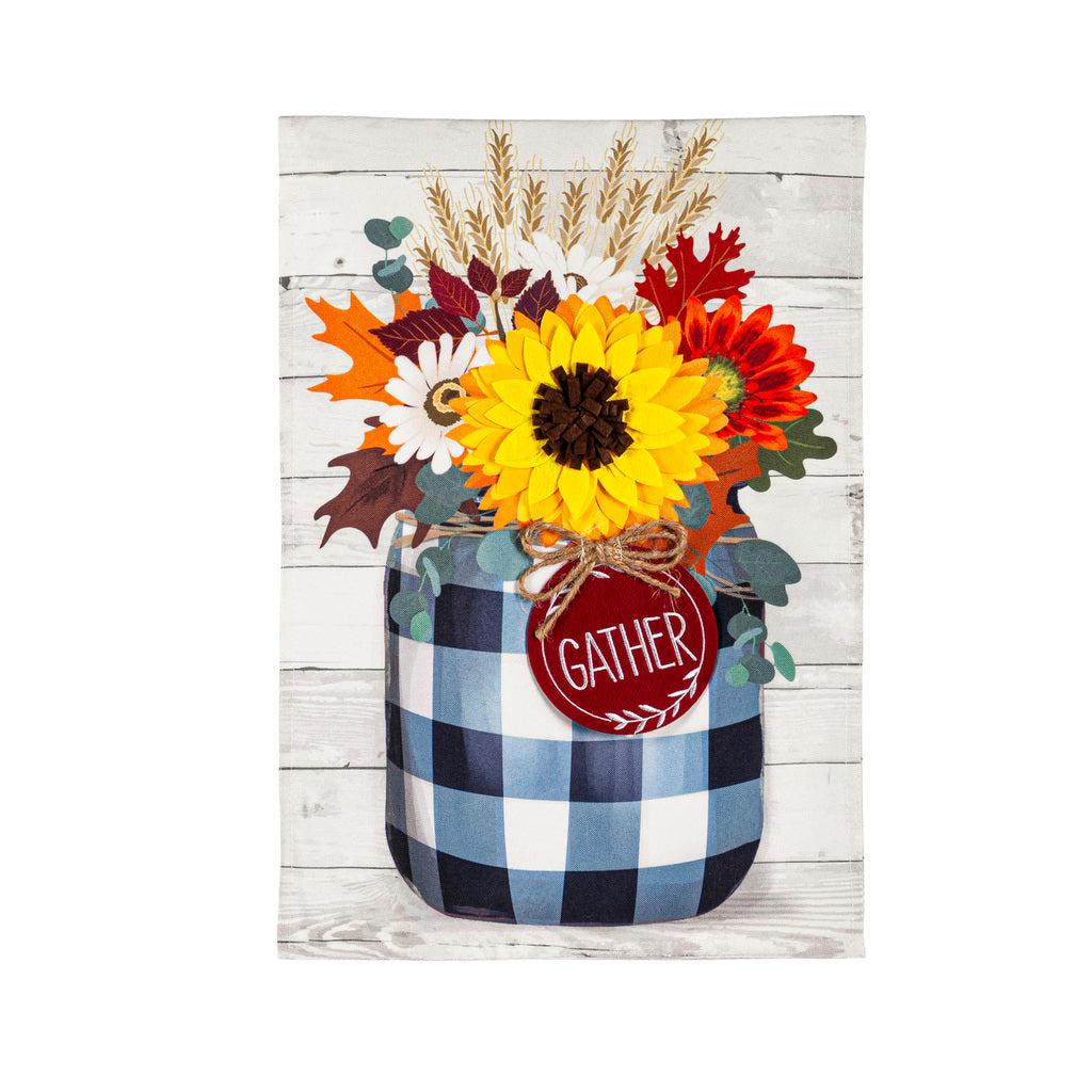 The Fall Check Mason Jar garden flag features an array of fall flowers in a black checked mason jar with a tag that says "Gather". 