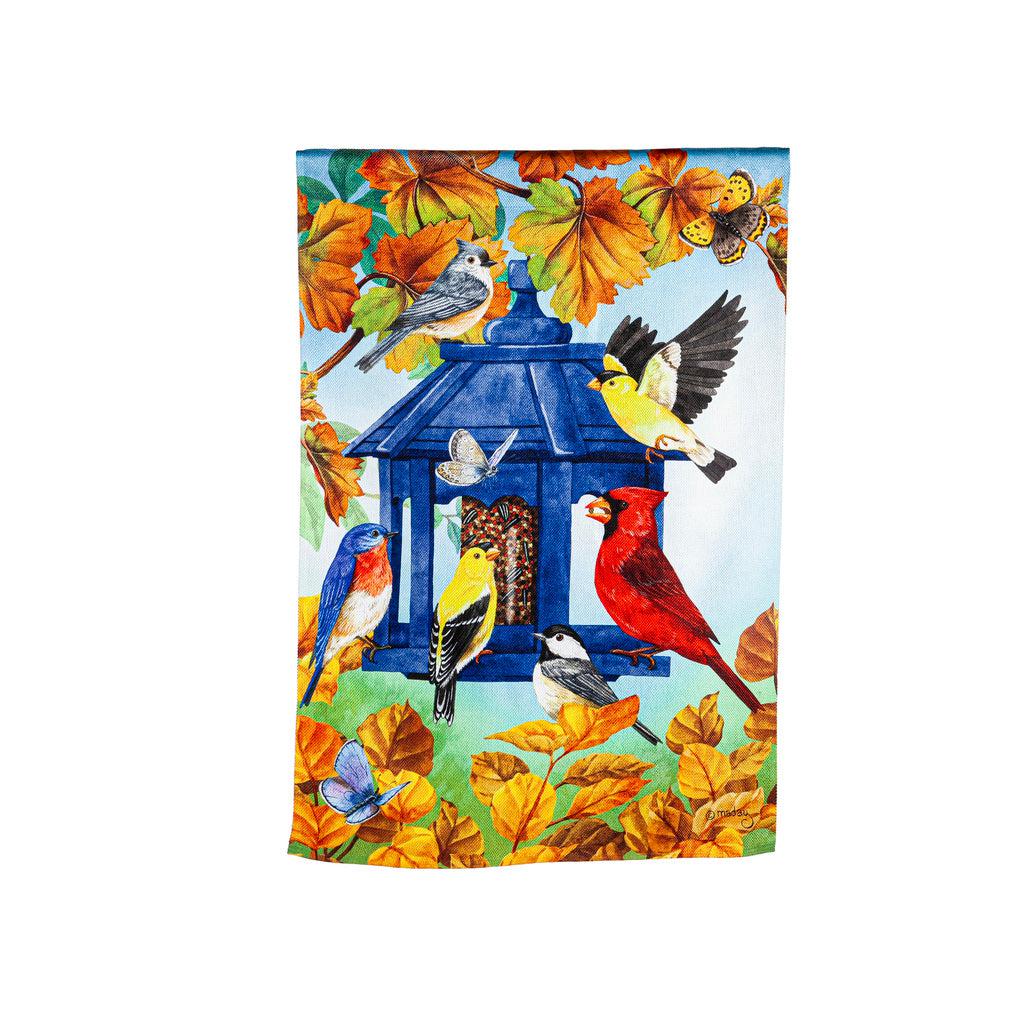 The Fall Feeder house banner features a multitude of birds feasting from a blue bird feeder surrounded by fall leaves.