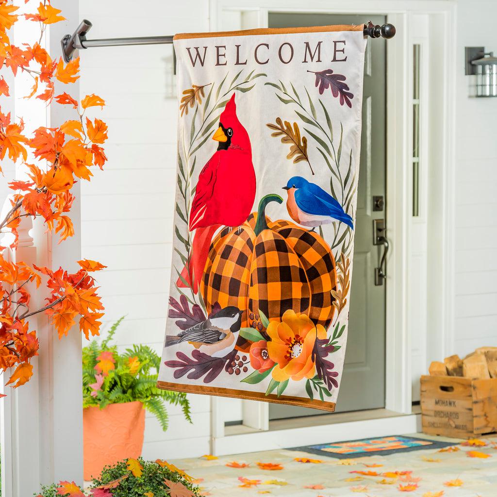 The Fall Songbirds house banner features a cardinal, bluebird, and chickadee gathered around an orange and black checked pumpkin and the word "Welcome" across the top. 
