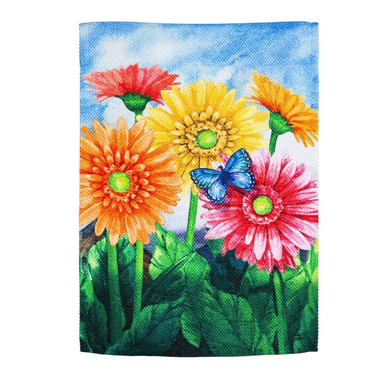 The Gerbera Daisies garden flag features brightly colored flowers on a sky blue background.