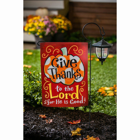 The Give Thanks to the Lord garden flag features a spotted pumpkin on an orange background and the words "Give Thanks to the Lord for He is Good".