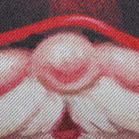 The Gnome With a Christmas Wreath garden flag features a smiling gnome sporting a pine wreath decorated in Christmas lights. 
