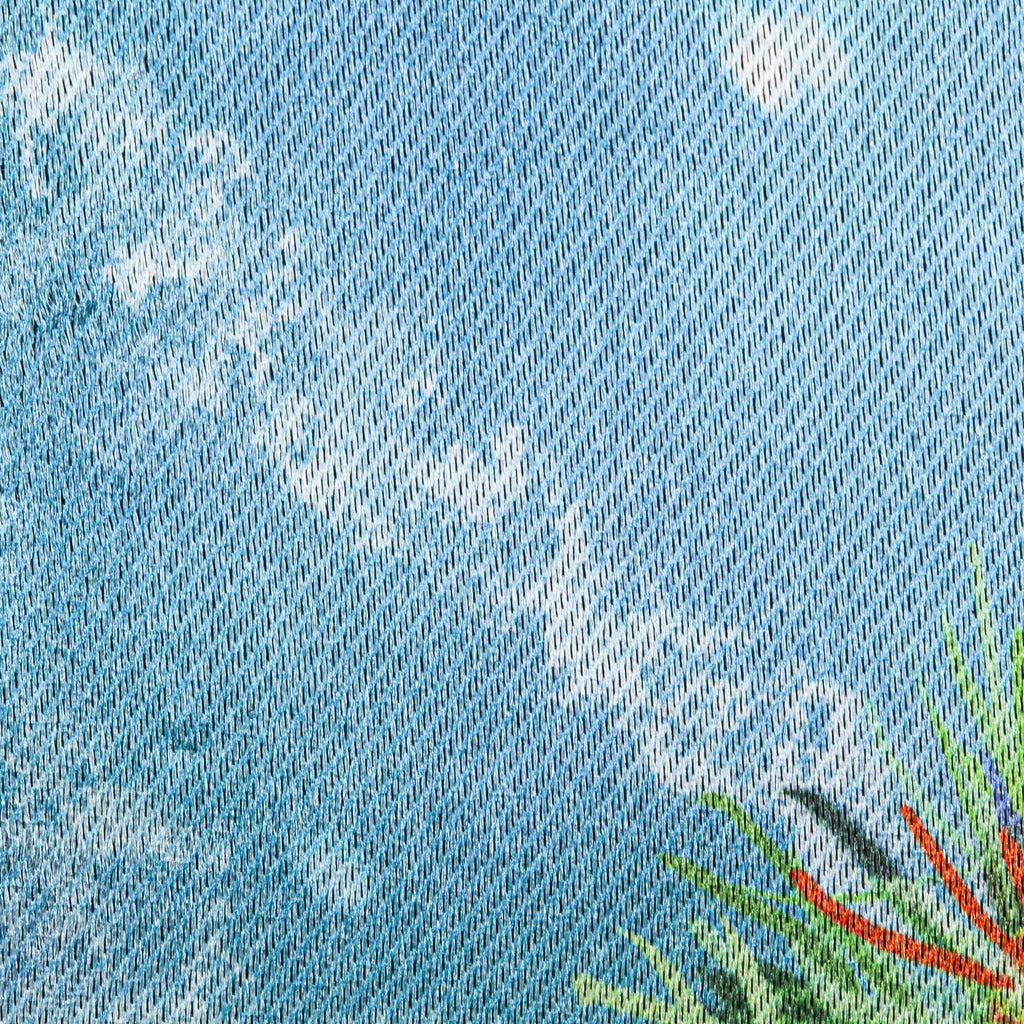 The Gnome With a Christmas Wreath garden flag features a smiling gnome sporting a pine wreath decorated in Christmas lights. 