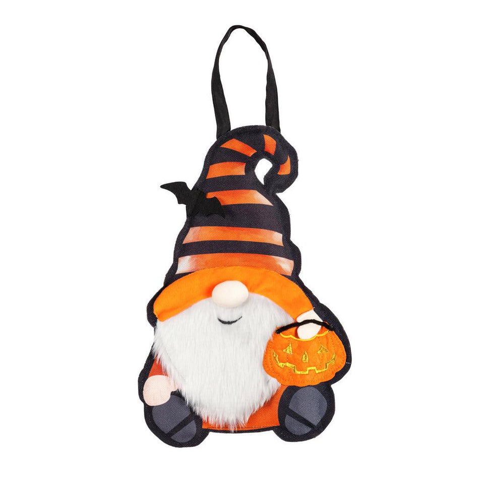 The Halloween Gnome door décor features a smiling gnome dressed in orange and black stripes and holding a jack-o-lantern bowl.