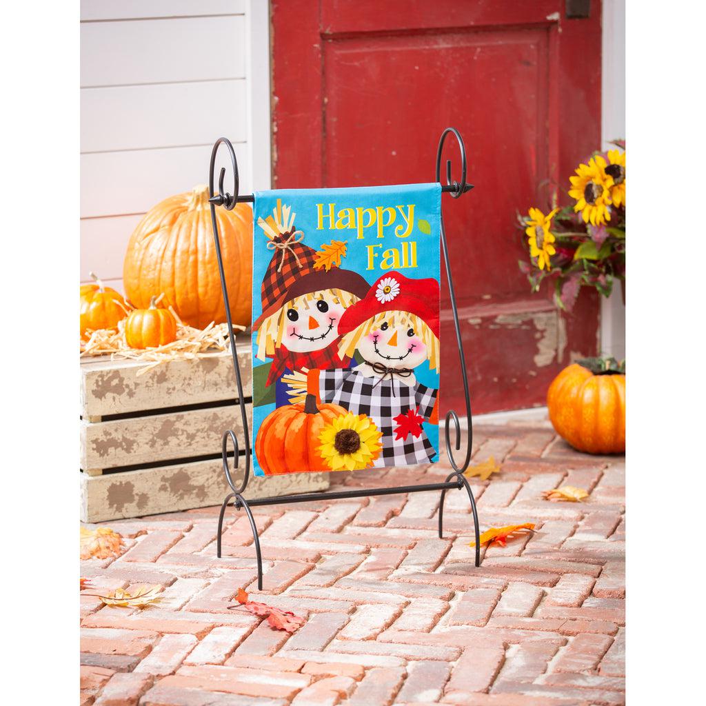 Our Happy Scarecrow Couple garden flag features a pair of smiling scarecrows with a pumpkin and the words "Happy Fall".  