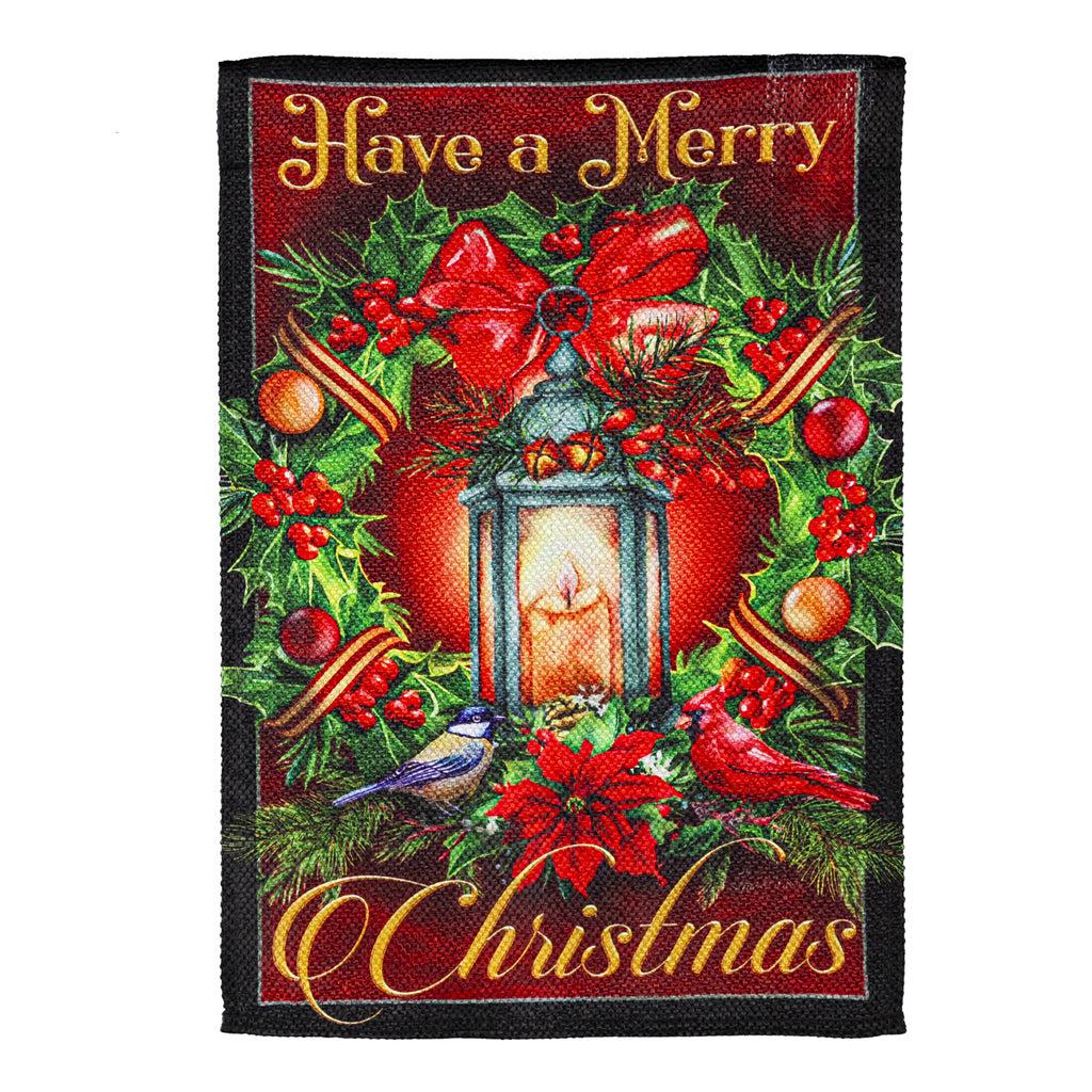 The Have a Merry Christmas Lantern garden flag features a vintage lantern surrounded by a holiday wreath and the words "Have a Merry Christmas".