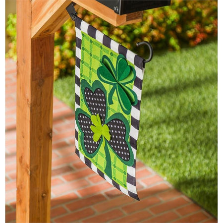 The Mixed Print Shamrocks garden flag features shamrocks, plaids, polka dots and blocks in shades of green, black and white