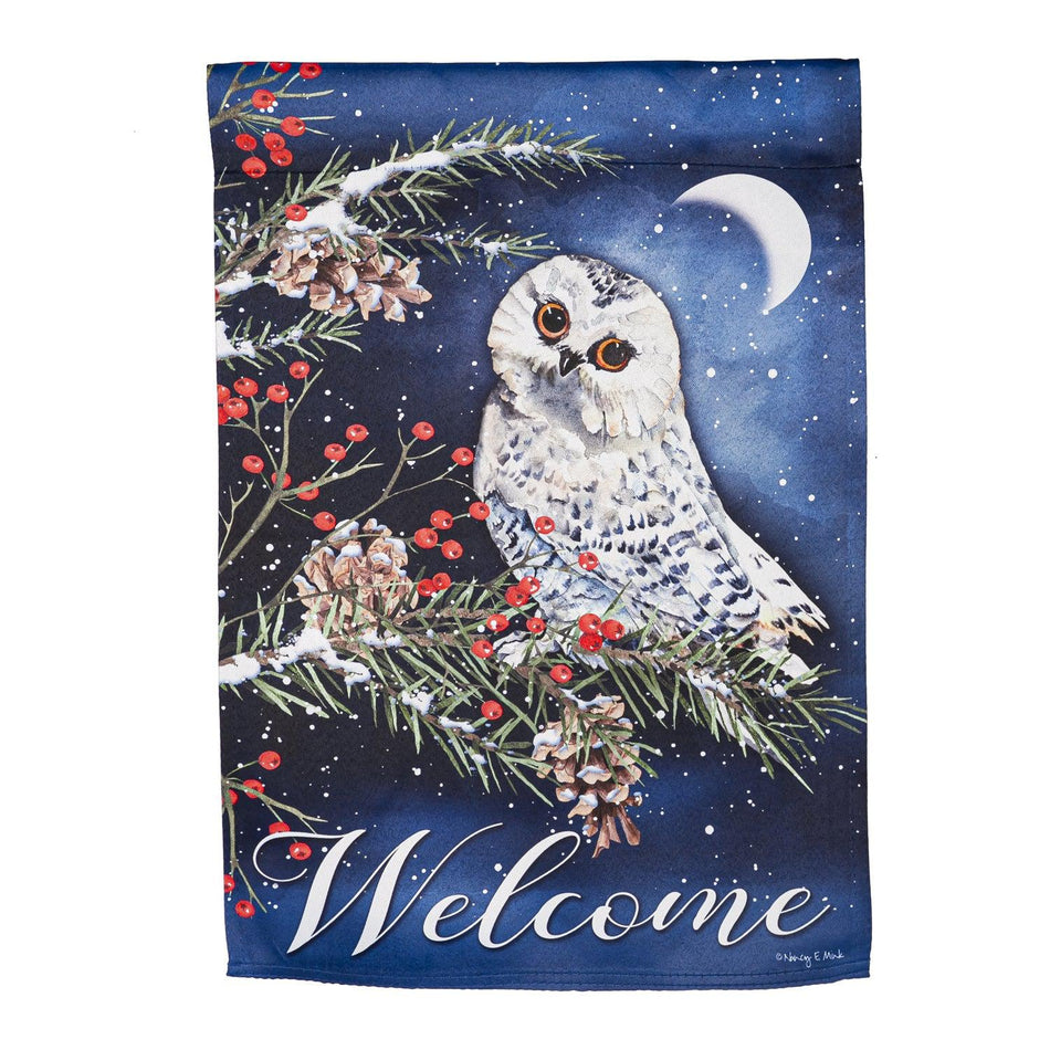 The Owl's Winter Greeting garden flag features a snowy owl at night resting on a pine branch along with the word "Welcome". 
