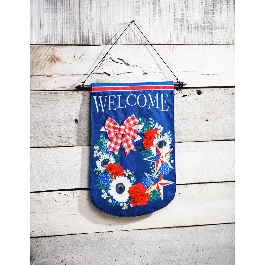 The Patriotic Floral Wreath garden flag features a red, white, and blue wreath made from flowers and stars, and the word "Welcome" at the top. 