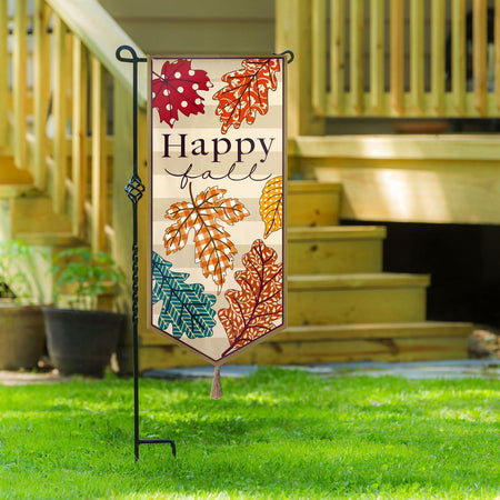 The  Patterned Leaves Textile Decor from the Everlasting Impressions collection features autumn colored leaves and the words "Happy Fall". This extra-long garden flag also has a tassel at the bottom center and 3D embroidered details.
