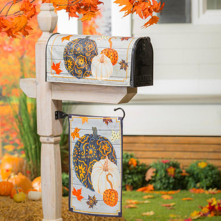 The Patterned Pumpkins and Leaves garden flag features three designed pumpkins in black, orange, and white with fall leaves floating down. 