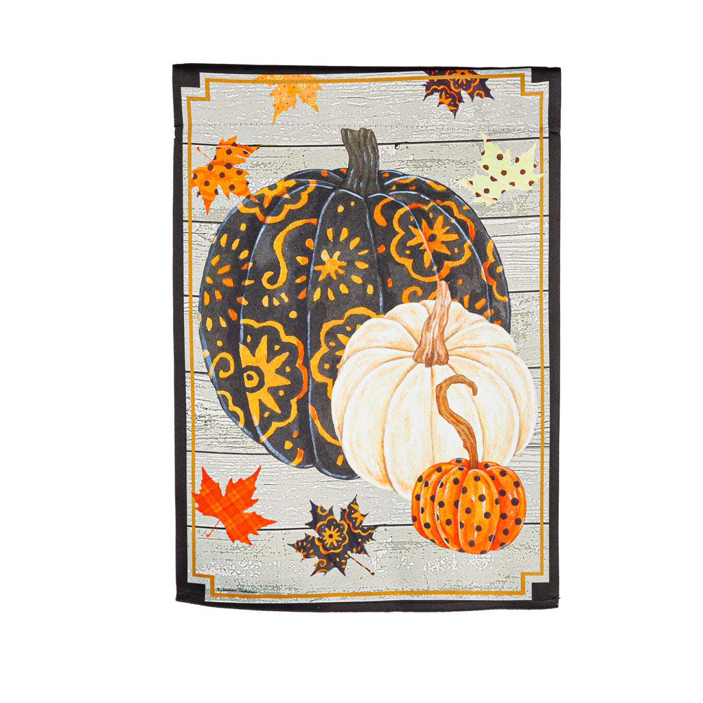The Patterned Pumpkins and Leaves garden flag features three designed pumpkins in black, orange, and white with fall leaves floating down. 