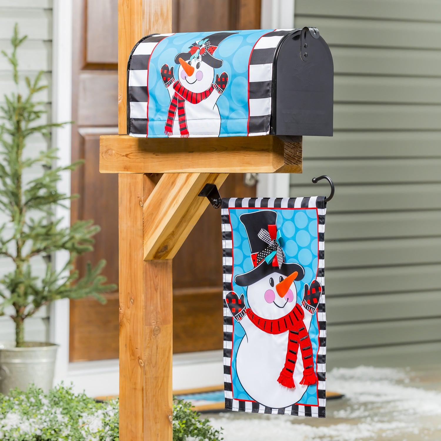 The Patterned Snowman garden flag features a happy snowman over a blue circle print background with a black and white checked border. 