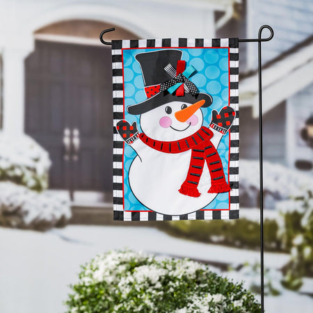 The Patterned Snowman garden flag features a happy snowman over a blue circle print background with a black and white checked border. 