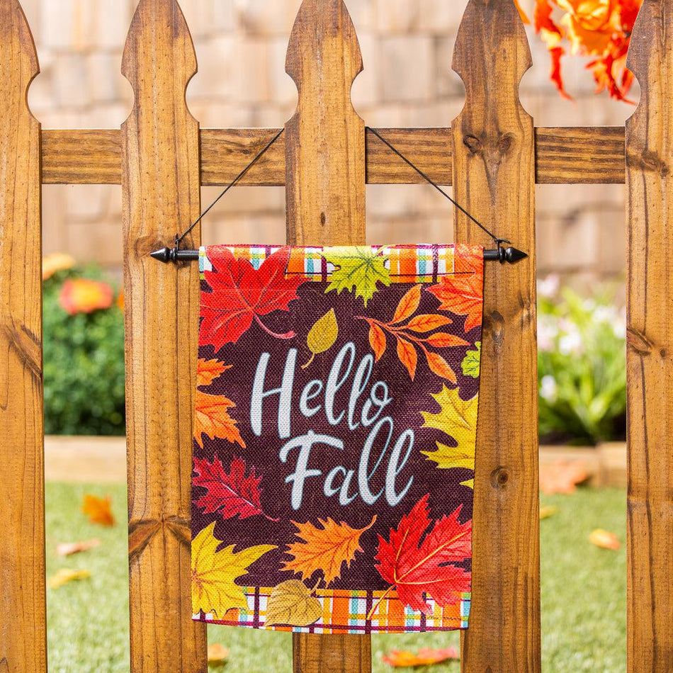 The Plaid Hello Fall garden flag features a plaid top and bottom border and the words "Hello Fall" surrounded by fall leaves.