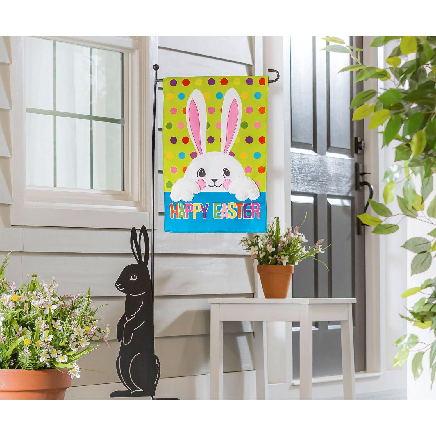 The Polka Dot Easter Bunny garden flag features a fuzzy white bunny over a brightly colored background with polka dots and the words "Happy Easter".