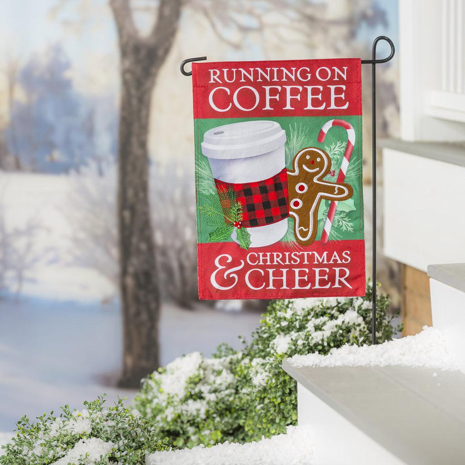 The Running on Coffee and Cheer garden flag features a to-go cup, gingerbread man and candy cane with the words "Running on Coffee & Christmas Cheer". 