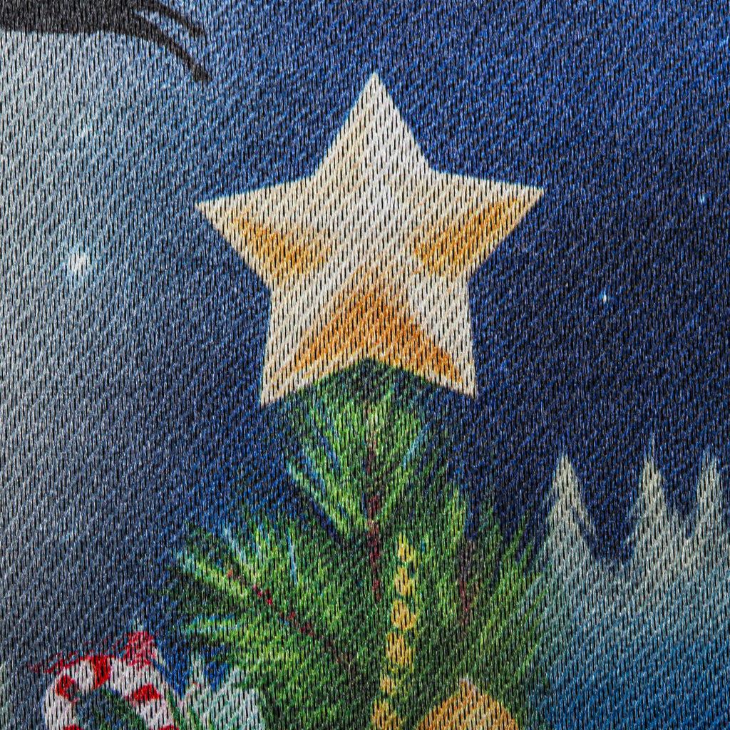 The Santa's Sleigh on Christmas garden flag features Santa and his reindeer flying over a small village with a beautiful Christmas tree, and the words "Merry Christmas" across the top. 