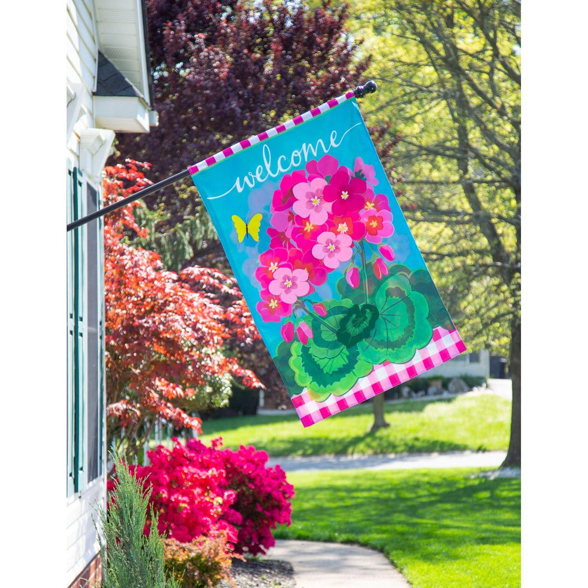 The Spring Geraniums house banner features vivid pink geraniums with hot pink checked top and bottom borders and the word "Welcome" across the top. 