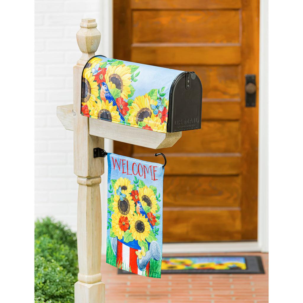The Stars and Stripes Watering Can garden flag features bright yellow flowers in a patriotic watering can and the word "Welcome" across the top. 