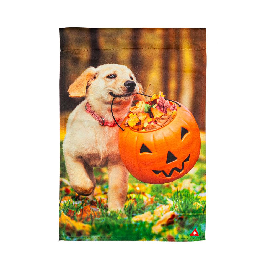 The Trick or Treat Puppy garden flag features an adorable puppy running with a jack-o-lantern bucket full of candy. 
