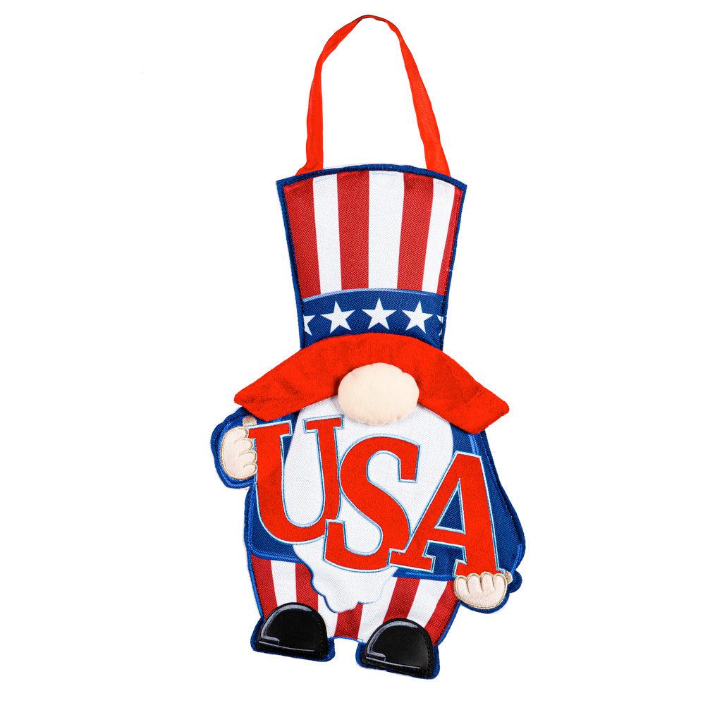 The USA Gnome door décor features a patriotic gnome dressed in stars and stripes and holding the letters USA. 