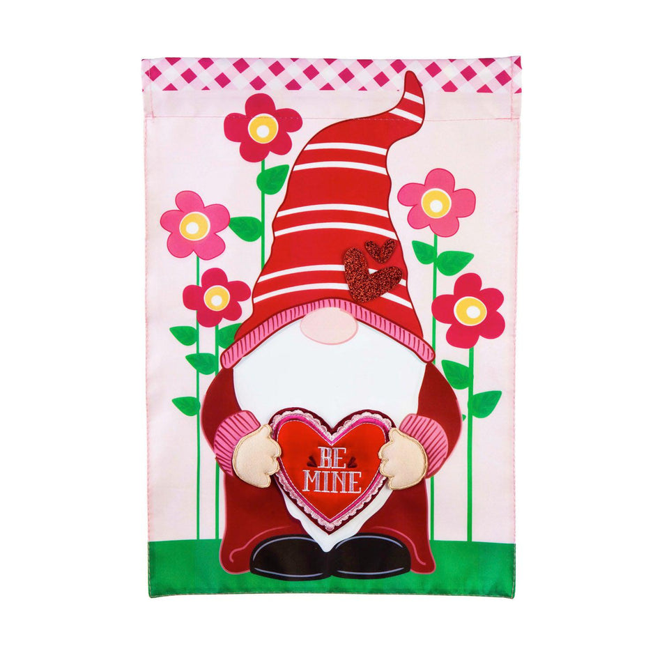 The Valentine Gnome garden flag features a gnome dressed in red holding a heart that says "Be Mine".