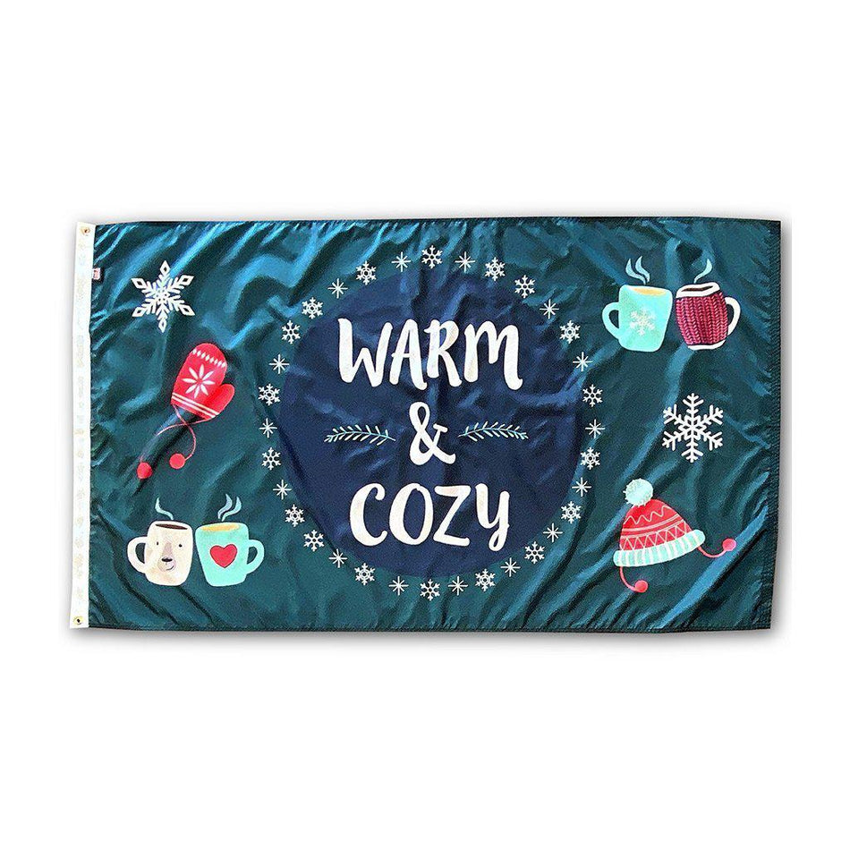 Our 3' x 5' Warm & Cozy Winter flag features snowflakes, a hat, mittens, and warm drinks along with the words "Warm & Cozy" on a navy and dark teal background.
